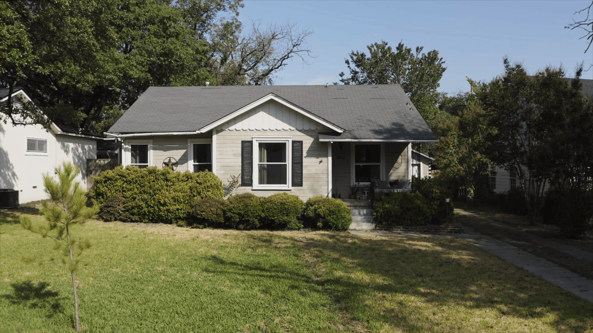 Decide to Re-side: Front of home with damaged wood siding Front of home with damaged wood siding