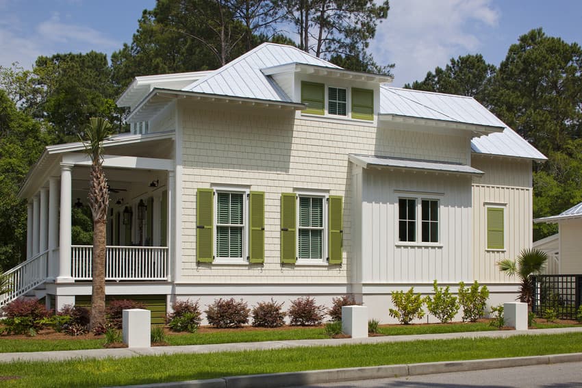 new-home-shutters House with white lap siding featuring bright olive-green shutters.